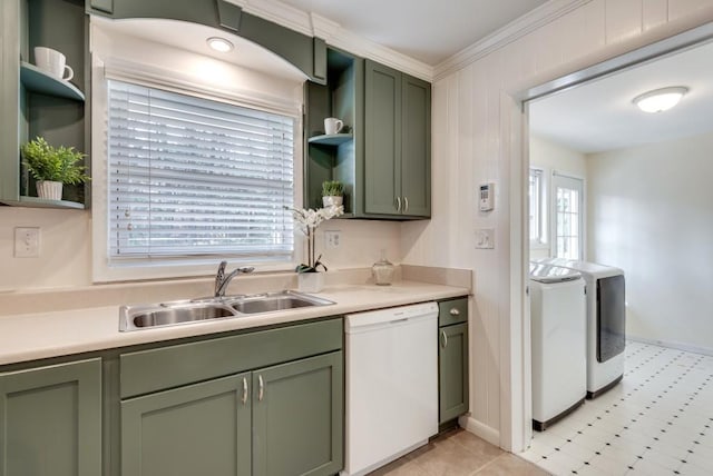 kitchen featuring washer and clothes dryer, dishwasher, sink, green cabinetry, and crown molding