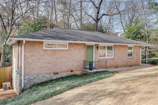 ranch-style home featuring a front lawn and central AC