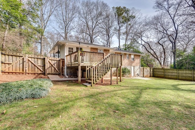 rear view of house featuring a deck and a lawn