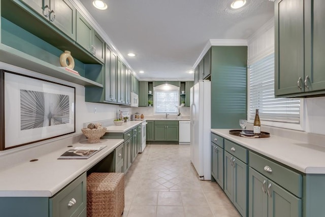 kitchen with green cabinets, light tile patterned floors, crown molding, and white appliances