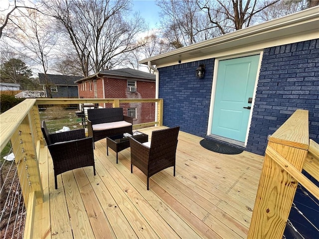 wooden terrace with an outdoor living space