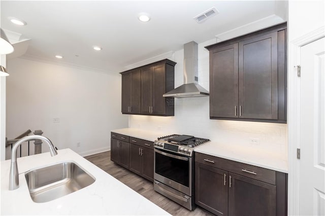 362 Olmstead Way Unit 23, Alpharetta, GA 30022 - kitchen featuring stainless steel gas range, wall chimney range hood, dark brown cabinets, wood finished floors, and backsplash