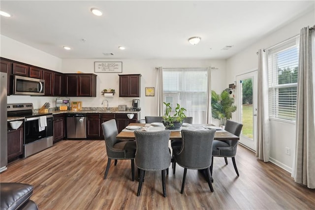 2051 Wildflower Way, Conyers, GA 30012 - dining space featuring wood finished floors, recessed lighting, and a healthy amount of sunlight