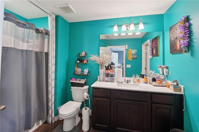 2051 Wildflower Way, Conyers, GA 30012 - full bathroom featuring wood finished floors, vanity, toilet, a shower with shower curtain, and visible vents