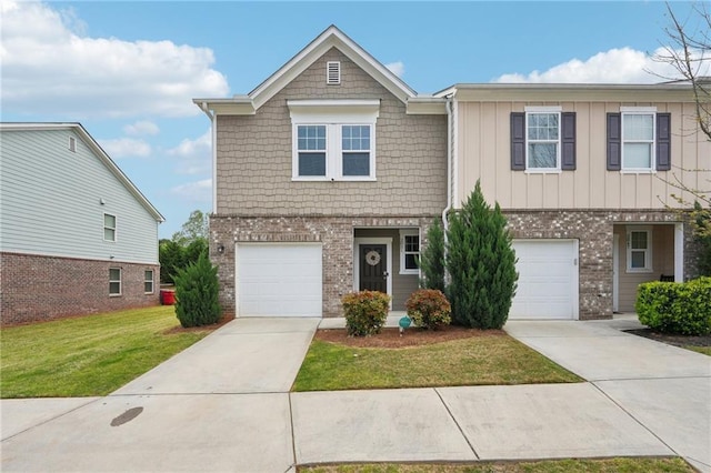 2051 Wildflower Way, Conyers, GA 30012 - view of front facade with concrete driveway, a front lawn, brick siding, and a garage