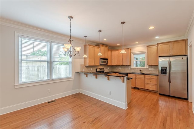 3404 Orchard St, Hapeville, GA 30354 - kitchen with stainless steel appliances, dark countertops, a breakfast bar area, crown molding, and tasteful backsplash