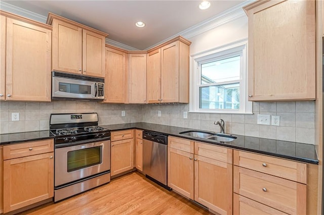3404 Orchard St, Hapeville, GA 30354 - kitchen featuring appliances with stainless steel finishes, light brown cabinets, crown molding, light wood-type flooring, and decorative backsplash