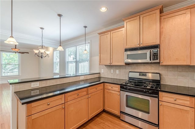 3404 Orchard St, Hapeville, GA 30354 - kitchen with stainless steel appliances, light brown cabinetry, a peninsula, ornamental molding, and light wood finished floors