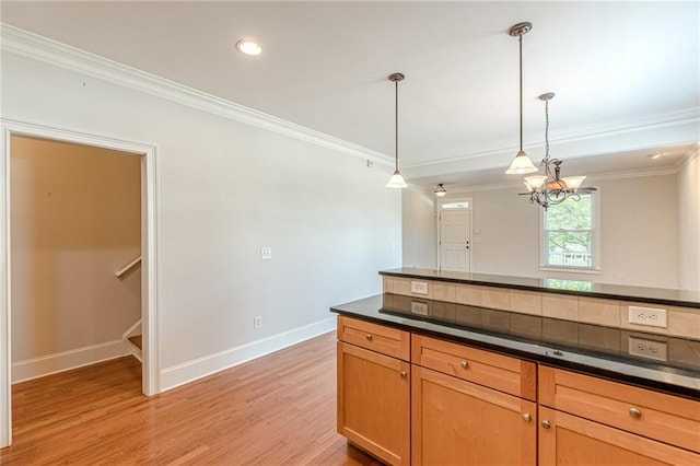 3404 Orchard St, Hapeville, GA 30354 - kitchen featuring dark countertops, light wood-style floors, crown molding, decorative light fixtures, and a chandelier