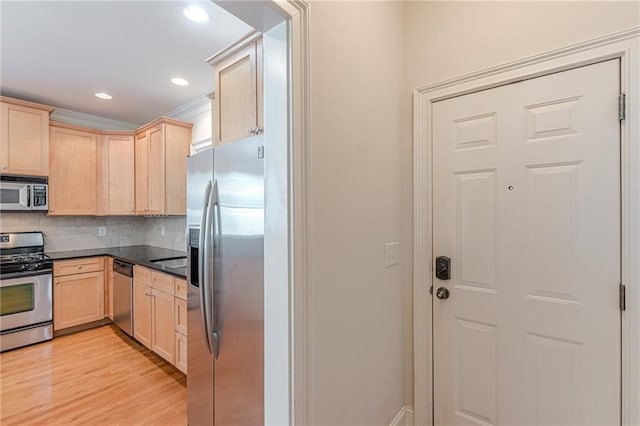 3404 Orchard St, Hapeville, GA 30354 - kitchen with stainless steel appliances, light brown cabinets, dark countertops, light wood-style floors, and backsplash