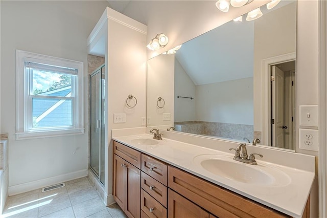 3404 Orchard St, Hapeville, GA 30354 - full bathroom with tile patterned floors, double vanity, vaulted ceiling, a shower stall, and a tub to relax in