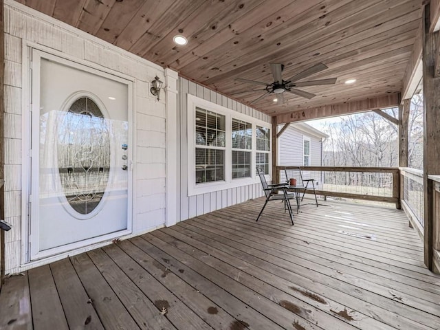 wooden deck with a porch and ceiling fan