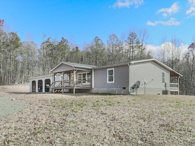 back of property with a garage and an outdoor structure