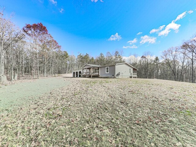 back of house with a lawn