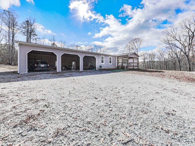 back of property featuring covered porch