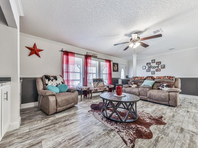 living room with ornamental molding, a textured ceiling, and hardwood / wood-style flooring