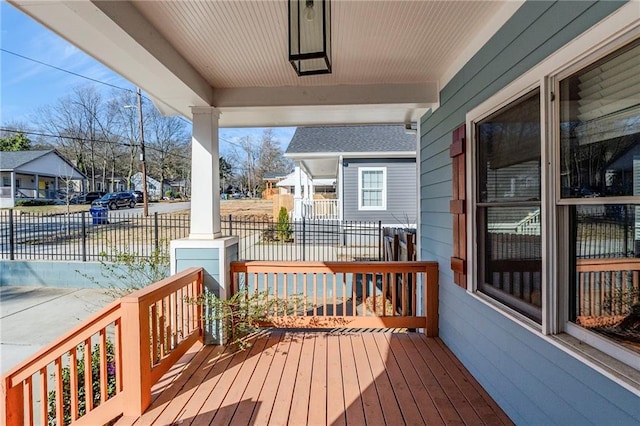 deck featuring covered porch and a residential view