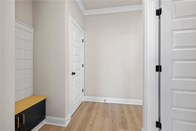 interior space with crown molding and light hardwood / wood-style flooring