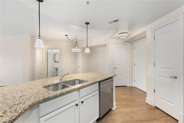 kitchen featuring stainless steel dishwasher, light wood-style flooring, white cabinets, a sink, and visible vents