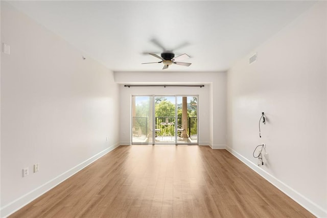 empty room with baseboards, visible vents, ceiling fan, and light wood finished floors