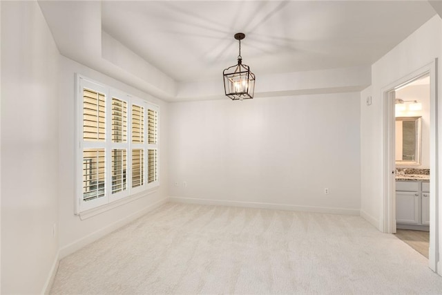 unfurnished room with light colored carpet and baseboards