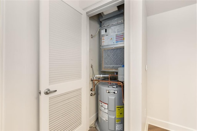 utility room featuring water heater