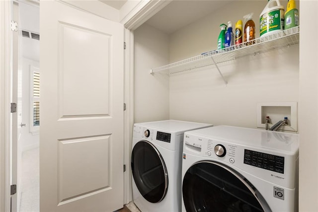 laundry area featuring washer and dryer, laundry area, and visible vents