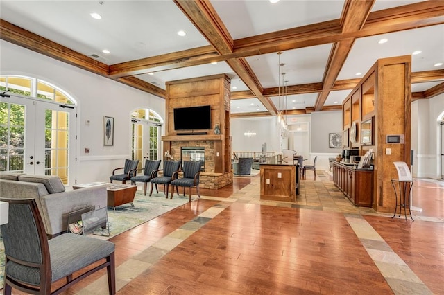 living room with french doors, recessed lighting, light wood finished floors, and beamed ceiling
