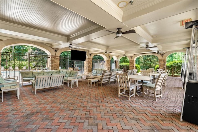 view of patio with an outdoor hangout area, fence, outdoor dining area, and ceiling fan