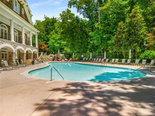 pool featuring a patio and fence