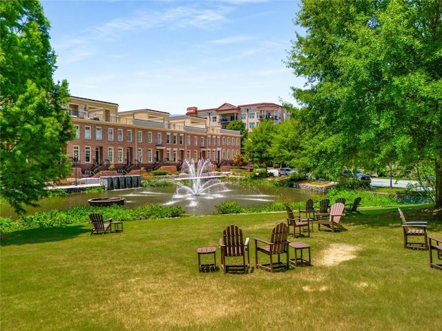 view of community featuring a water view and a lawn
