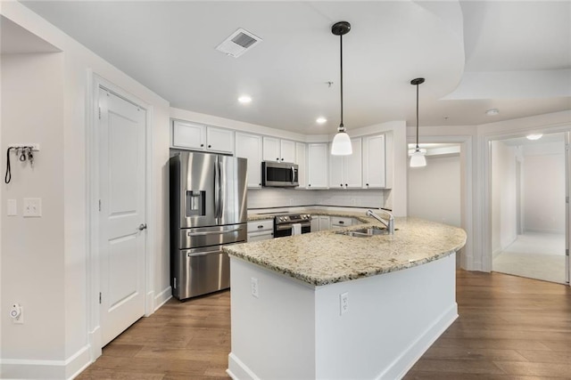 kitchen featuring dark wood-style flooring, a sink, appliances with stainless steel finishes, and visible vents