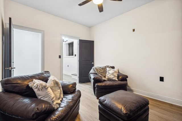 living room with light hardwood / wood-style floors and ceiling fan