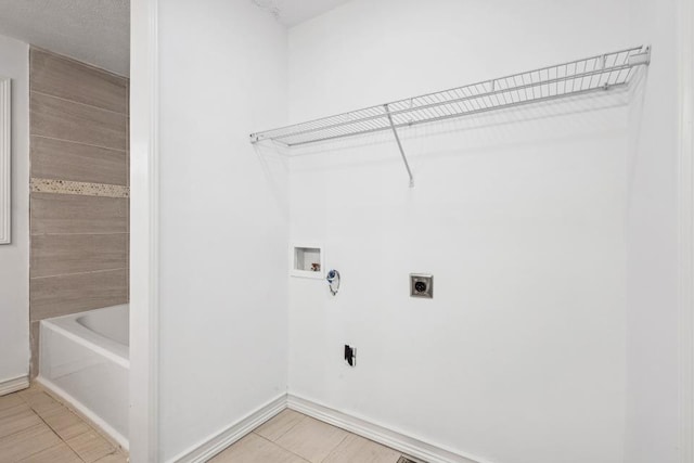 laundry room with tile patterned floors, hookup for a washing machine, and electric dryer hookup