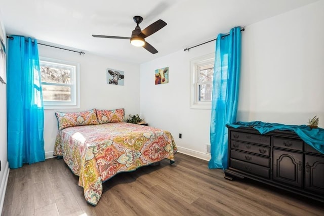 bedroom with ceiling fan, hardwood / wood-style floors, and multiple windows