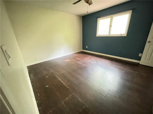 unfurnished bedroom featuring baseboards, a ceiling fan, a textured ceiling, and wood finished floors