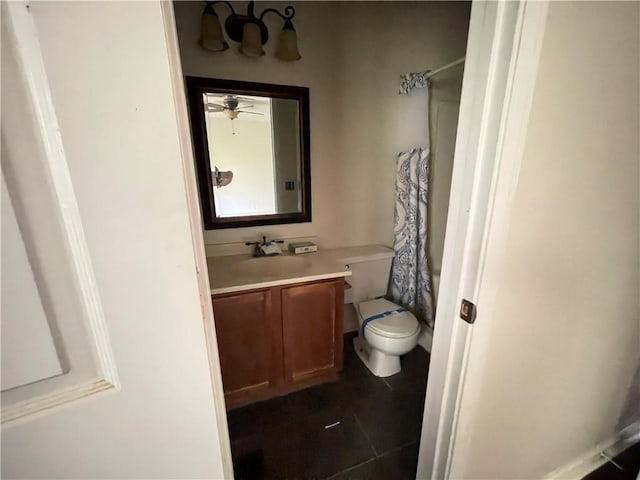 bathroom featuring vanity, curtained shower, toilet, tile patterned floors, and a ceiling fan