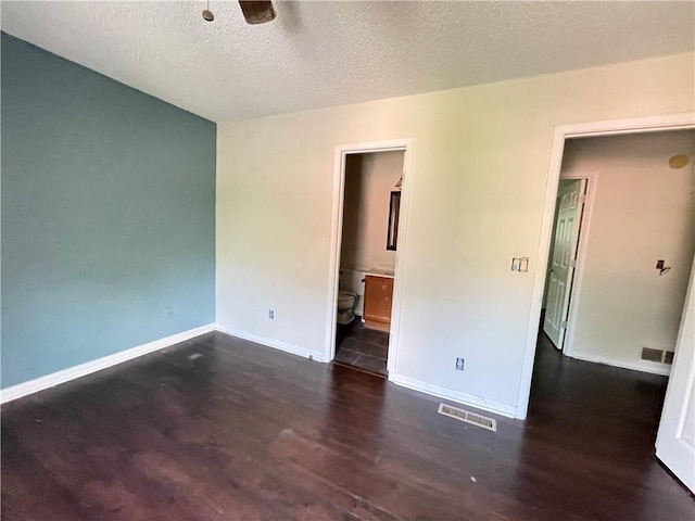 empty room featuring visible vents, wood finished floors, baseboards, ceiling fan, and a textured ceiling