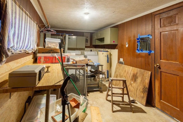 storage area featuring water heater and washer and clothes dryer