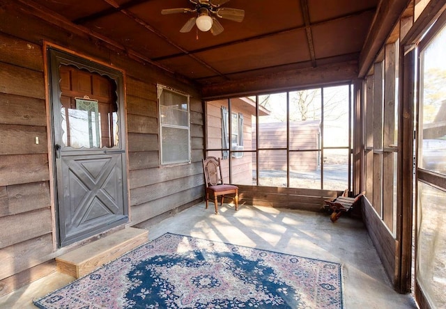 sunroom featuring ceiling fan