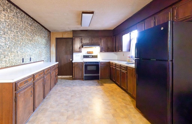 kitchen featuring black refrigerator, white electric range, and a textured ceiling