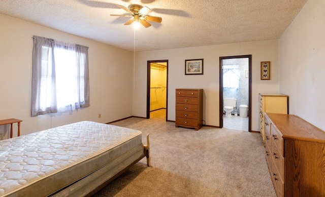 bedroom featuring multiple windows, light colored carpet, and a textured ceiling