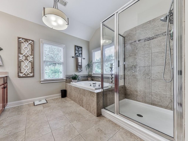 bathroom featuring a stall shower, vaulted ceiling, tile patterned floors, a bath, and vanity