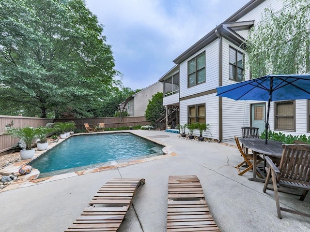 view of swimming pool featuring a fenced backyard and a patio area