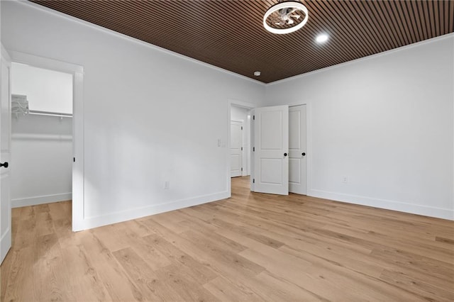 1337 Fairfield Dr, Lilburn, GA 30047 - unfurnished bedroom with light wood-style floors, ornamental molding, and a spacious closet