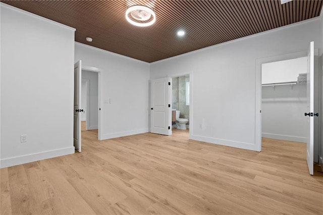 1337 Fairfield Dr, Lilburn, GA 30047 - unfurnished bedroom featuring ornamental molding, a walk in closet, light wood-type flooring, a closet, and connected bathroom