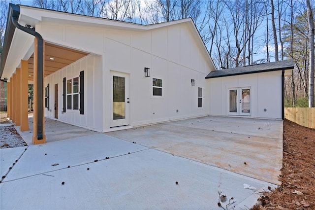 1337 Fairfield Dr, Lilburn, GA 30047 - rear view of property with board and batten siding, french doors, and a patio area
