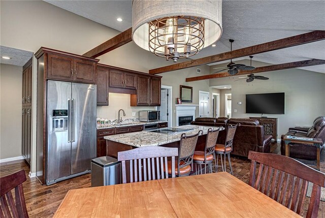 207A Quail Trl, Jackson, GA 30233 - kitchen with appliances with stainless steel finishes, a sink, ceiling fan, dark brown cabinetry, and an island with sink