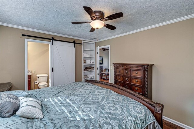 207A Quail Trl, Jackson, GA 30233 - bedroom with ornamental molding, a barn door, a textured ceiling, ceiling fan, and ensuite bathroom