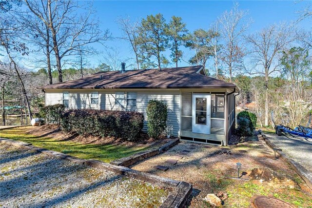 207A Quail Trl, Jackson, GA 30233 - view of front of property featuring a sunroom and roof with shingles